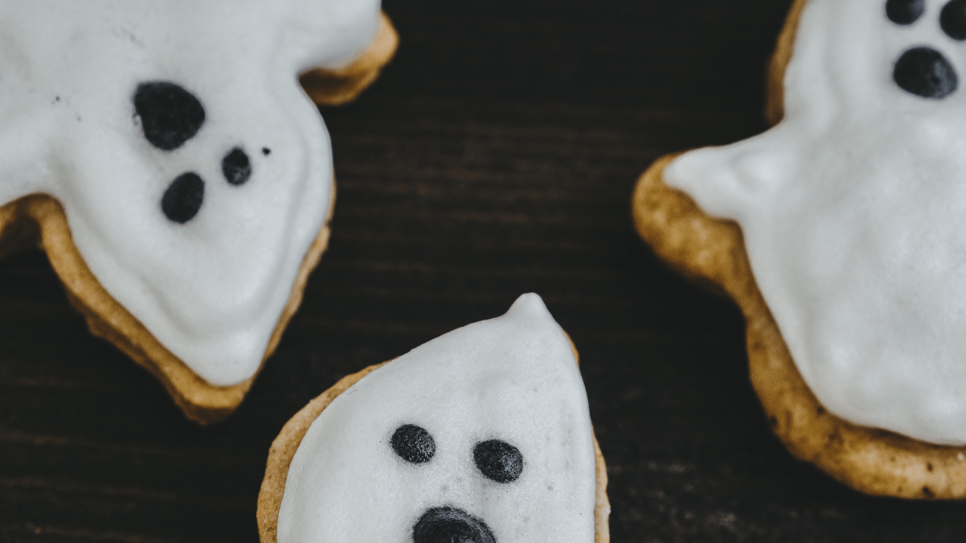 Assorted spooky Halloween snacks like mummy hot dogs, ghost cookies, and caramel apples with Recipe Memory