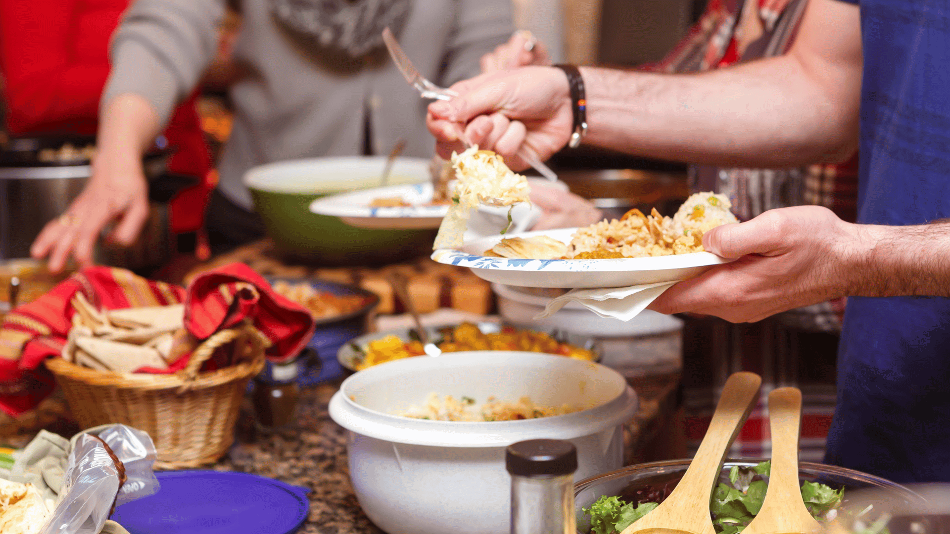 A festive game day table filled with wings, nachos, sliders, drinks, and desserts organized with Recipe Memory