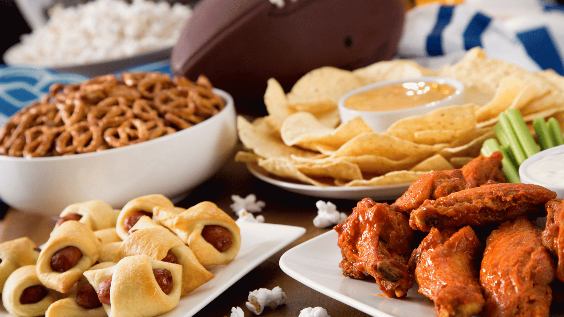 Table full of wings, nachos, and dips set for a game day Recipe Memory