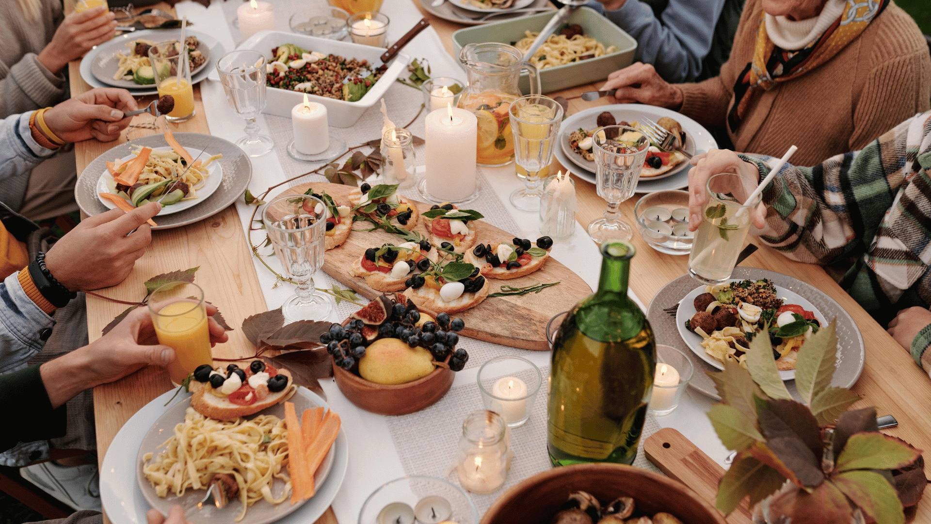 Family gathered around a kitchen table sharing recipes and stories with Recipe Memory