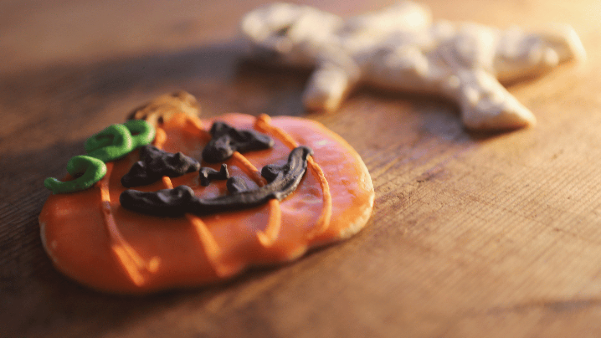 Family decorating Halloween cookies and caramel apples together using Recipe Memory