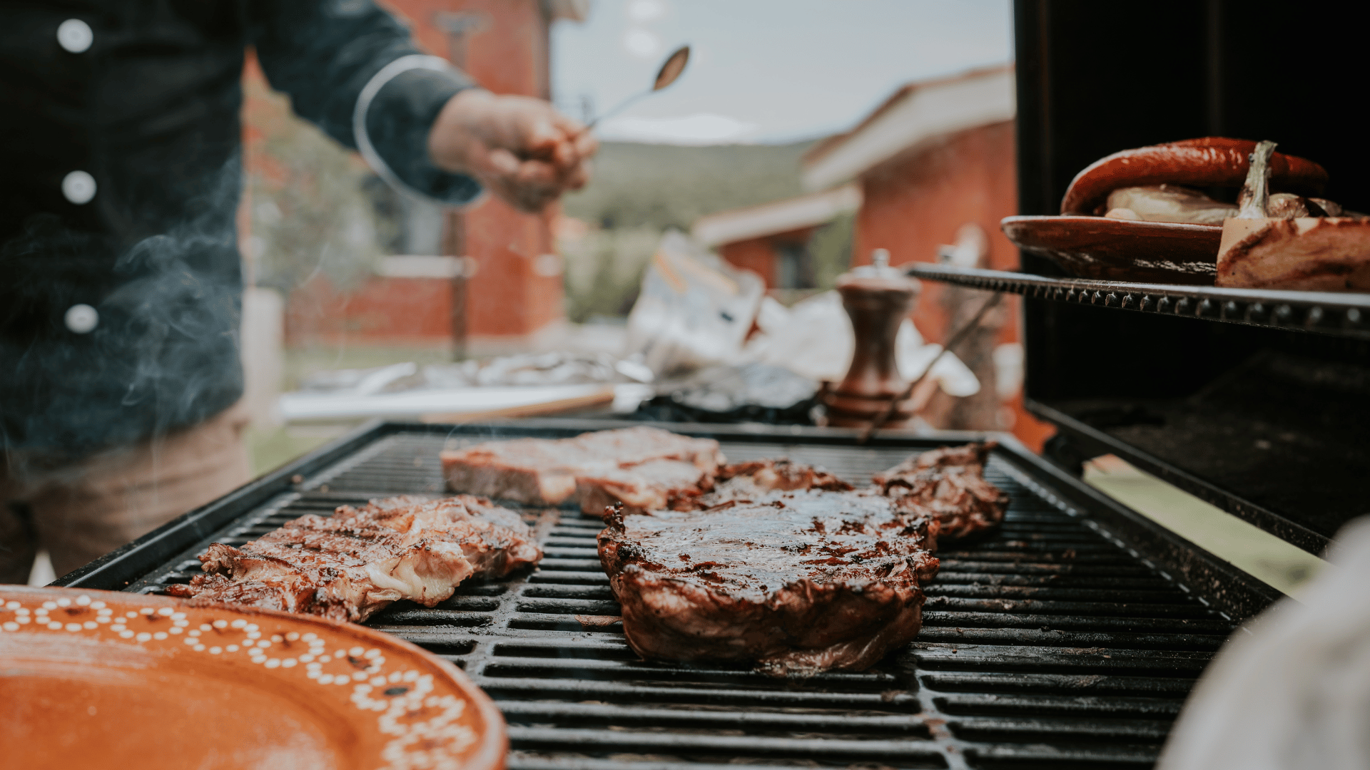 Tailgating spread with wings, sliders, nachos, and chili served outdoors with Recipe Memory