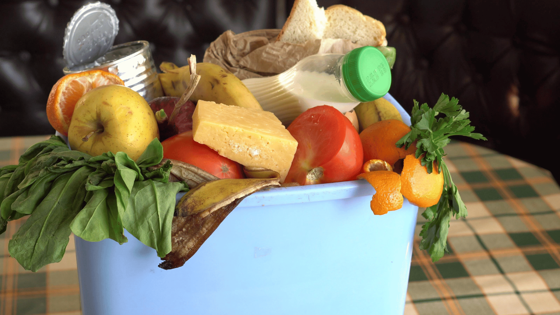 Fresh produce, grocery list, and meal planning calendar organized to reduce waste